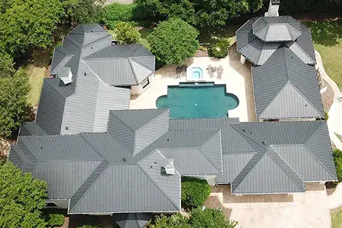Arial View of Large Home with Metal Roof and Gutters