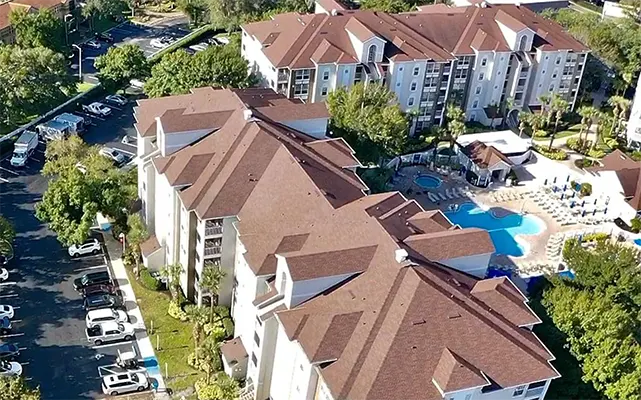Apartment Complex with Pool Reroofed by Certified Roofing Solutions